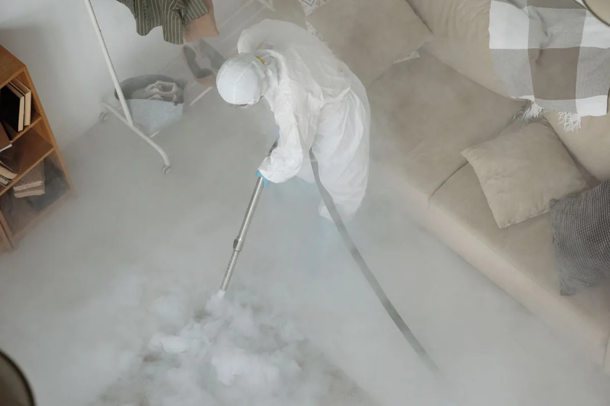Biohazard cleanup technician in protective equipment, St. George, MO